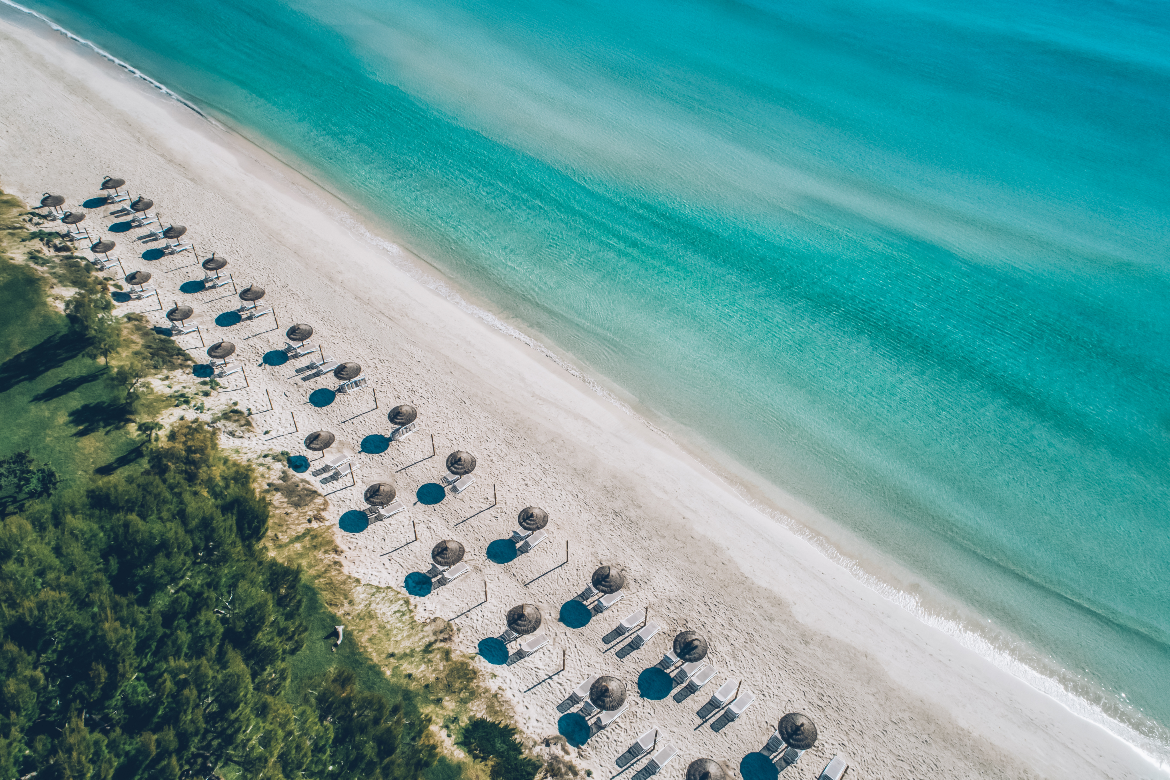 Aerial view of empty beach with umbrellas and chairs