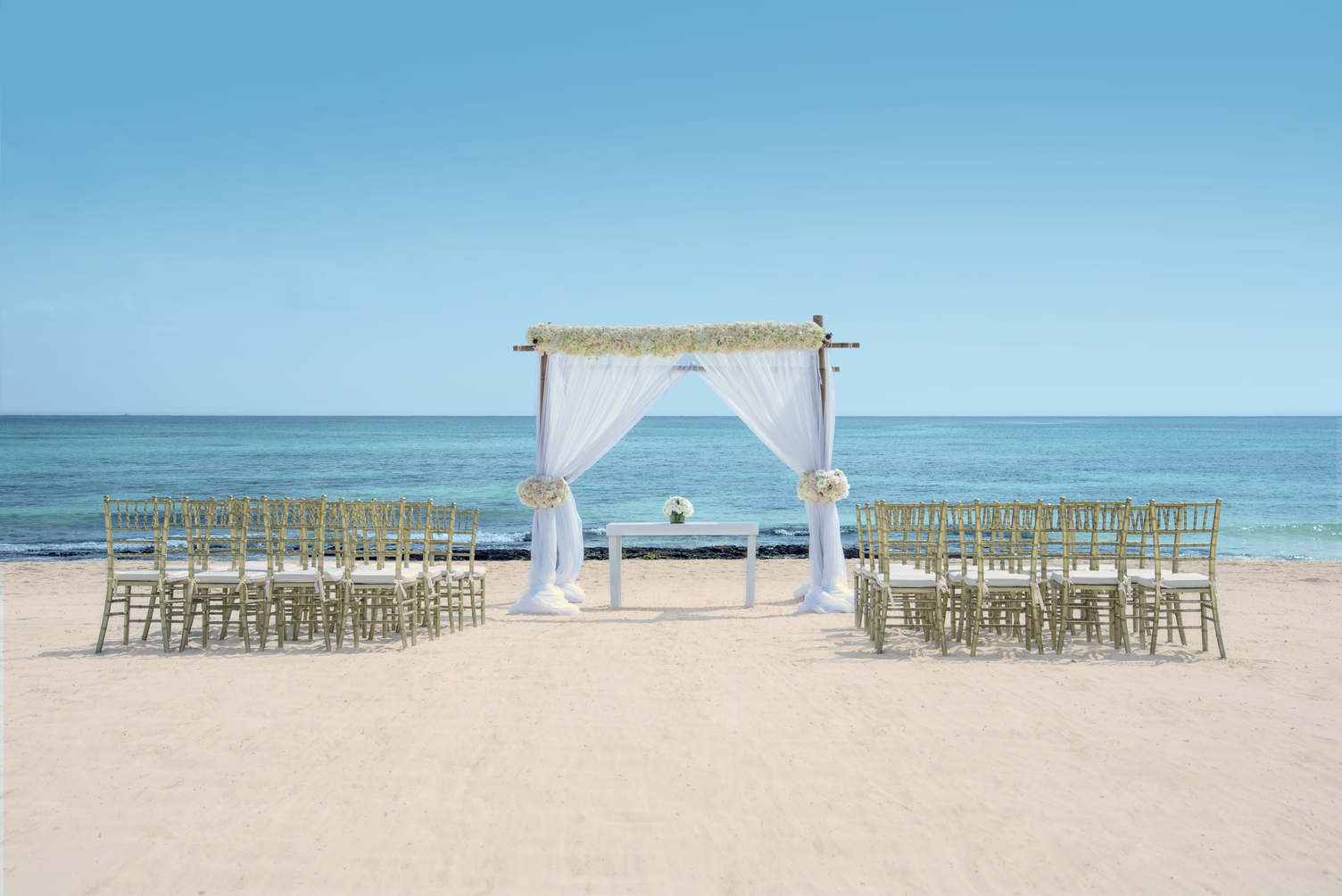 Elegant Beachfront Wedding Ceremony Setup with Chairs