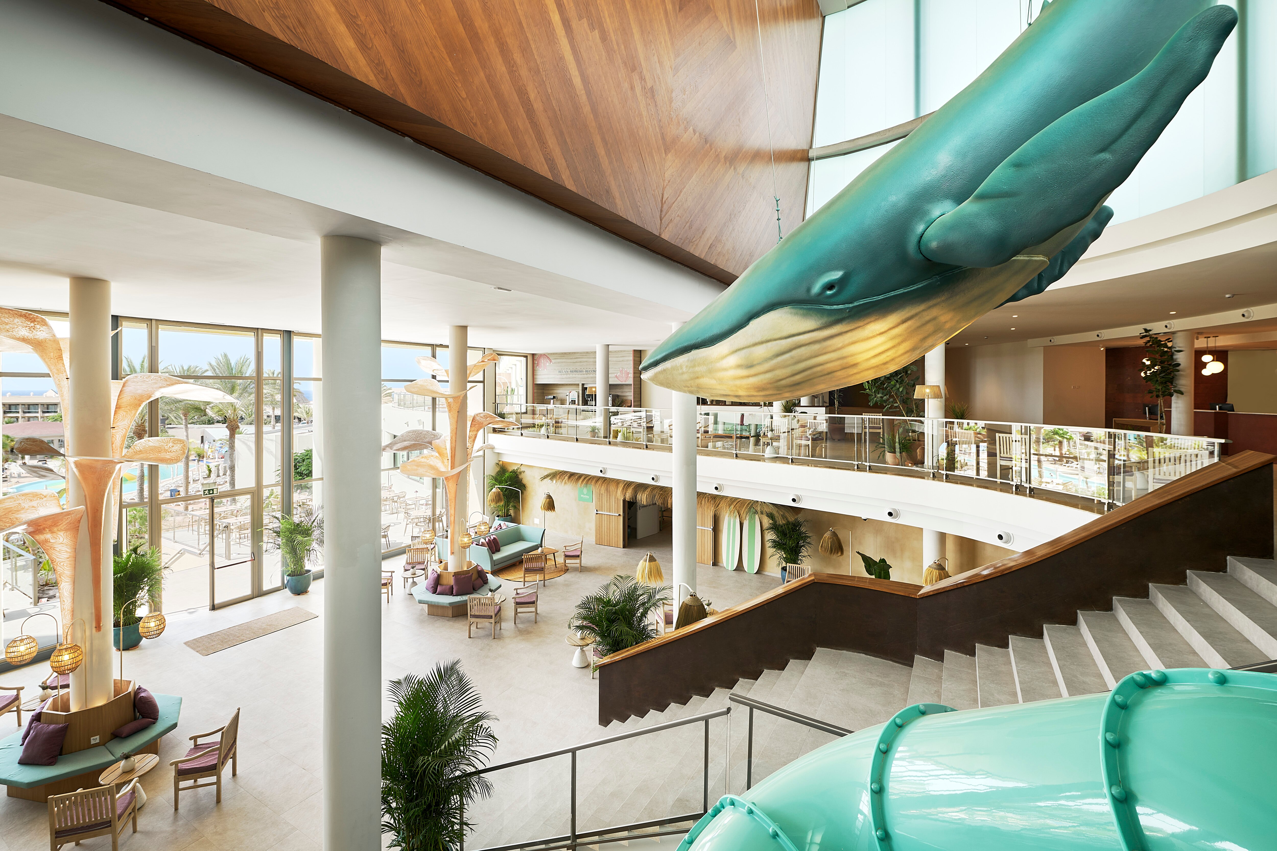 Modern hotel lobby with large whale sculpture centerpiece