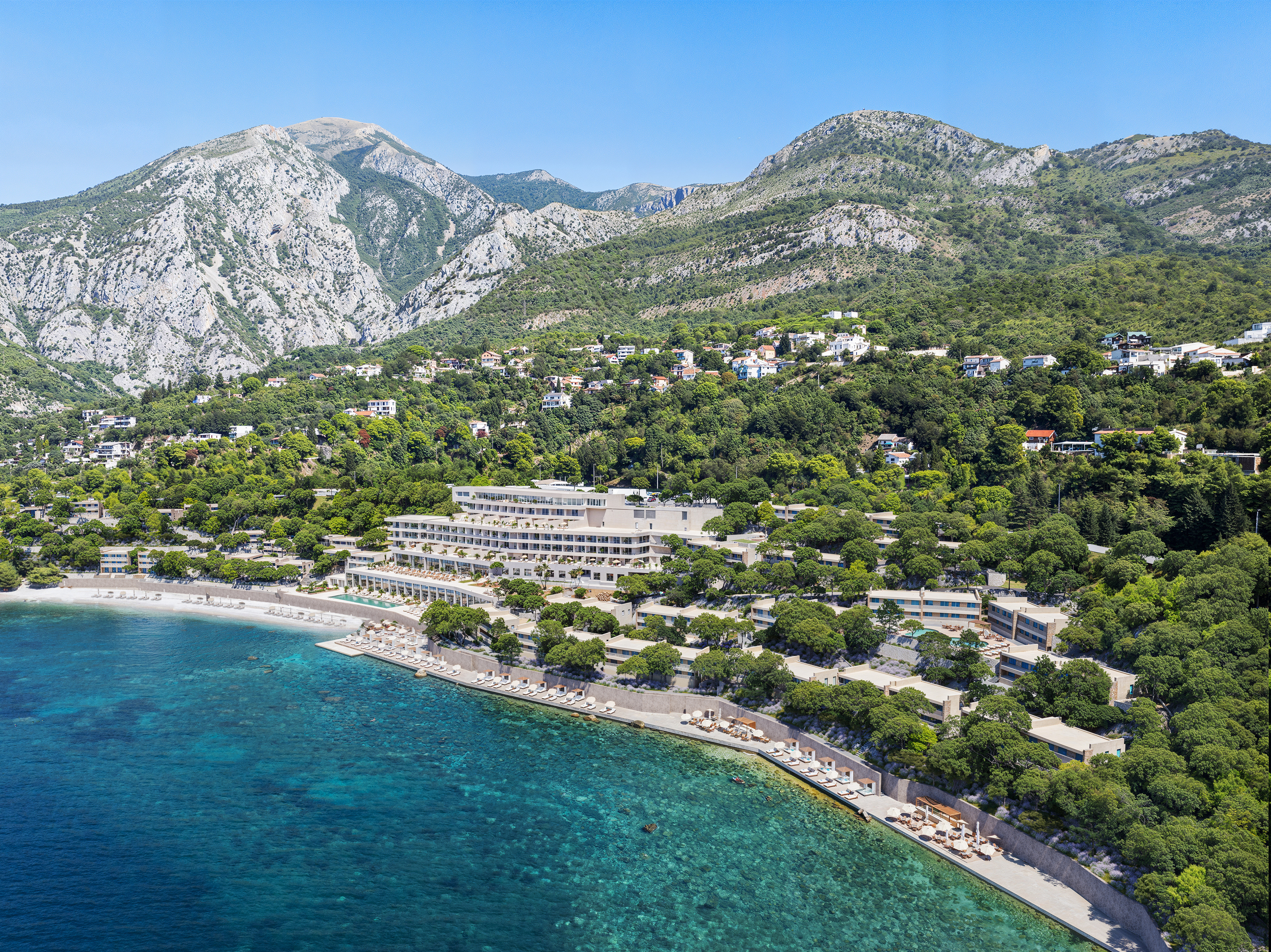 Aerial View of Coastal Resort with Mountain Backdrop